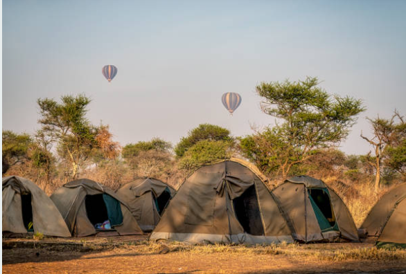Campers enjoying Bush Camping in Uganda surrounded by wildlife and beautiful natural landscapes.